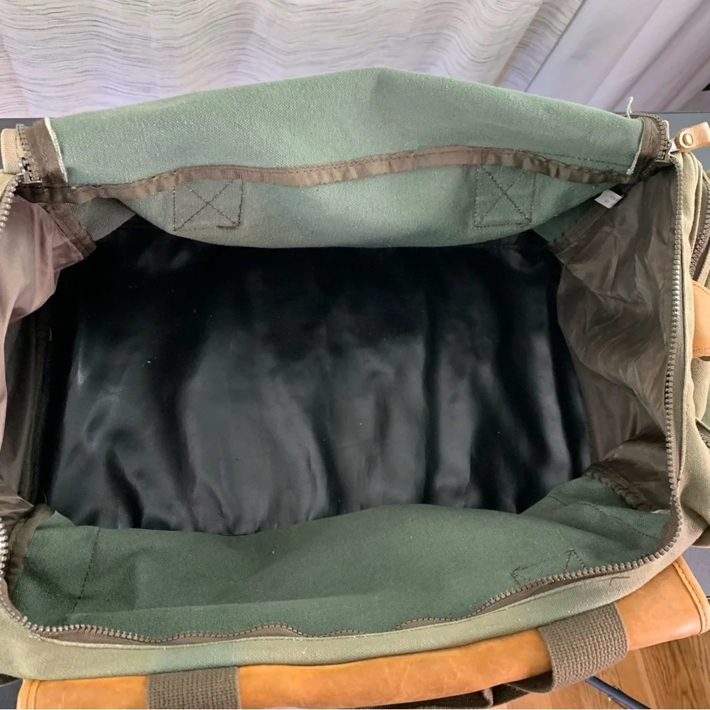 High Sierra Green canvas and Brown leather Duffel Bag.